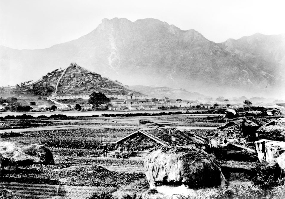 約1868年的九龍城，遠方可見1847年建成的城寨，其城牆一直伸延至白鶴山。(圖片 / 高添強)
